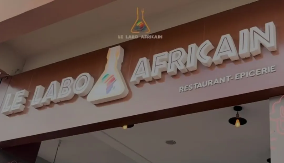 The Le Labo Africain restaurant-epicerie sign above the entrance