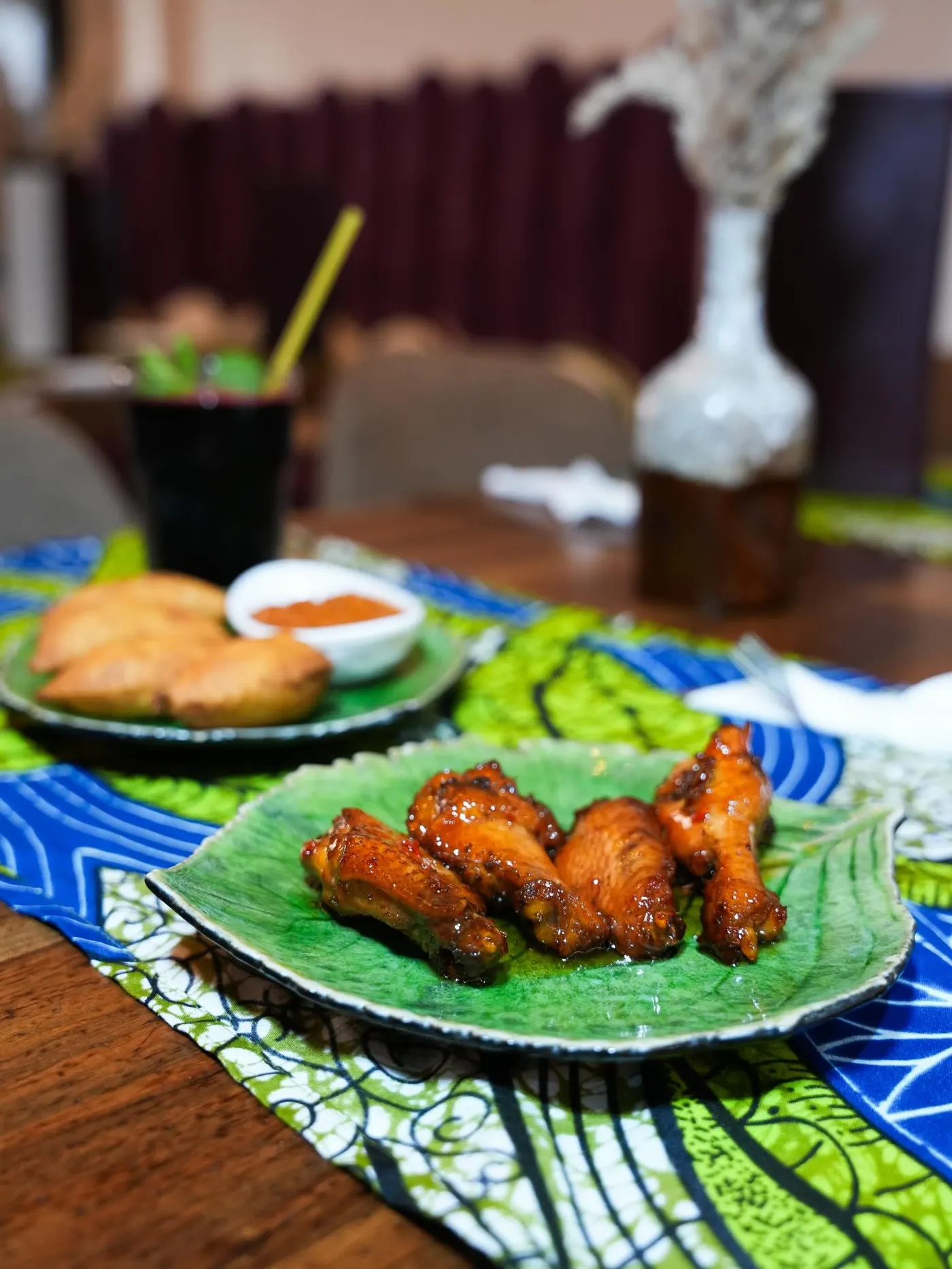 Grilled chicken with attieke on a wax-print cloth