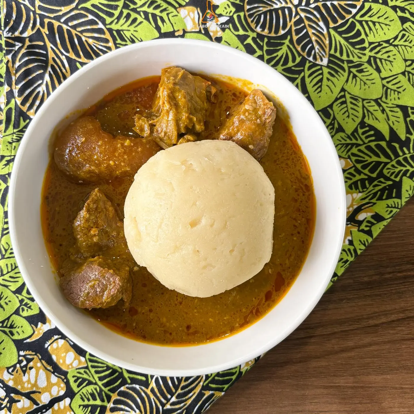A rich peanut simmer served with a ball of fufu
