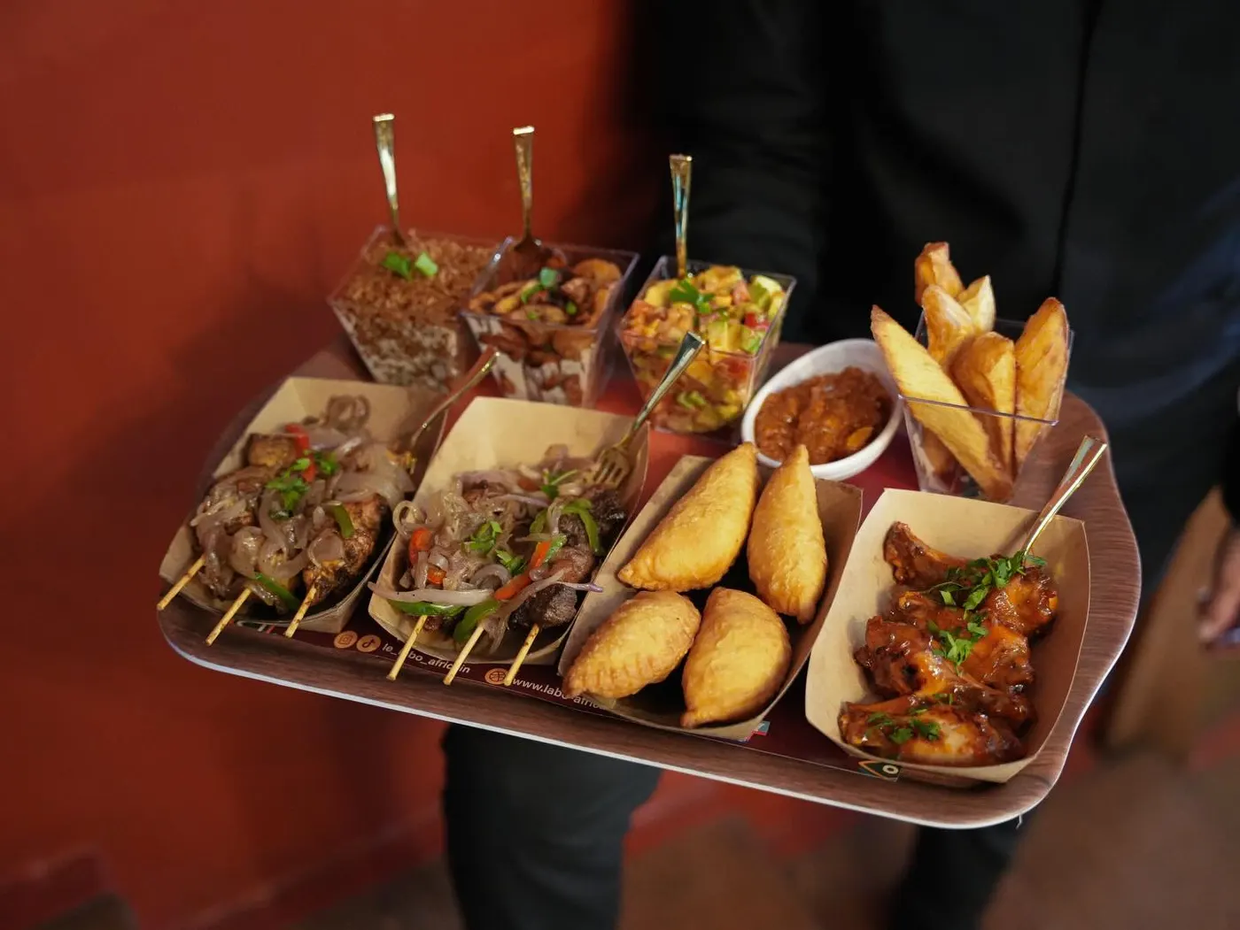 A platter of crisp fried pastels with dipping sauce