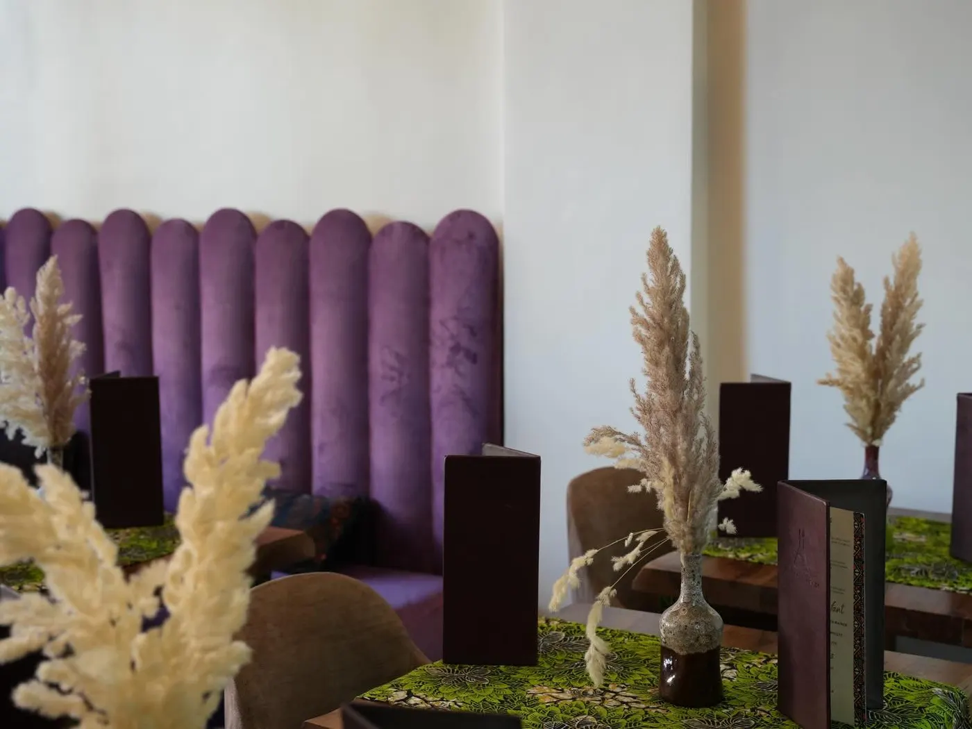 The purple velvet banquette with dried pampas grass