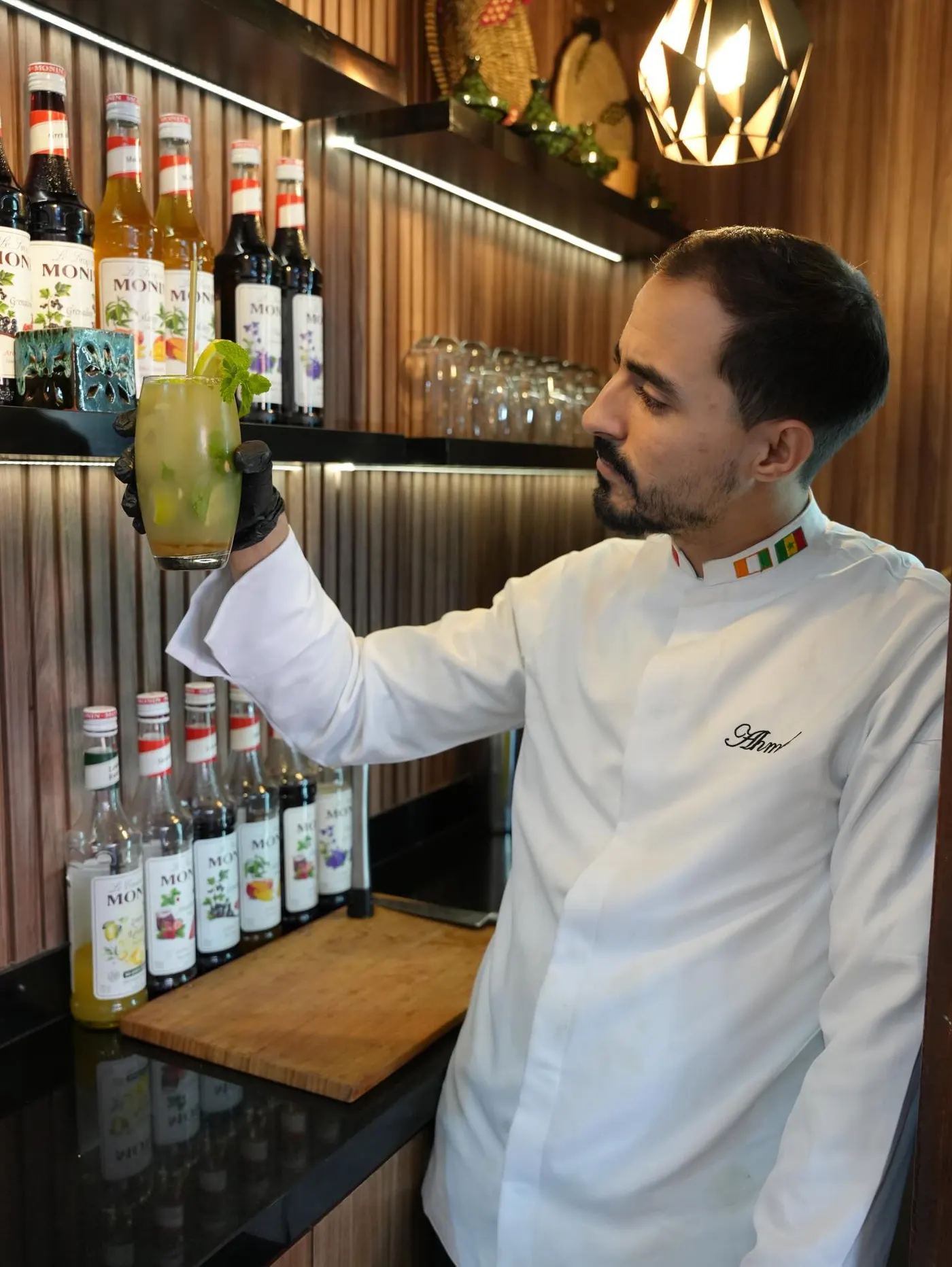 The chef and barman sharing a toast behind the bar